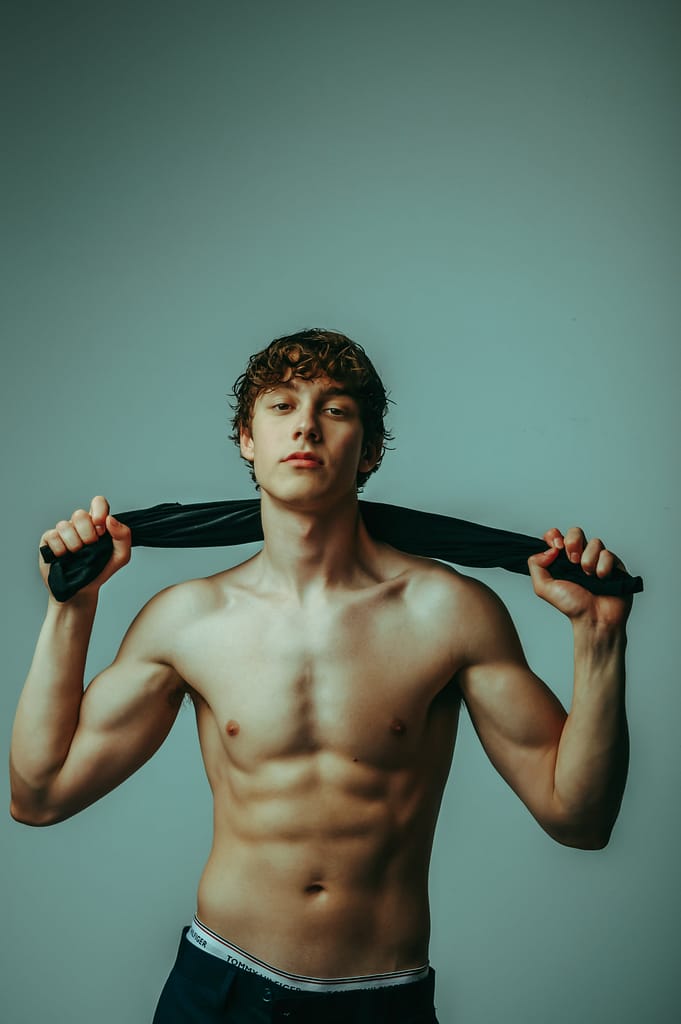 fit shirtless man holding towell