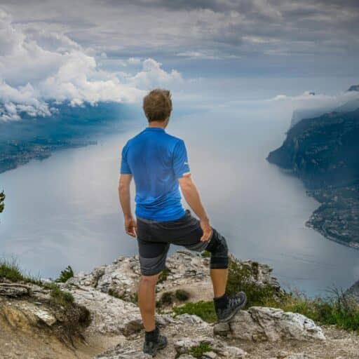 Picture of a man hiking and looking down at the beautiful view